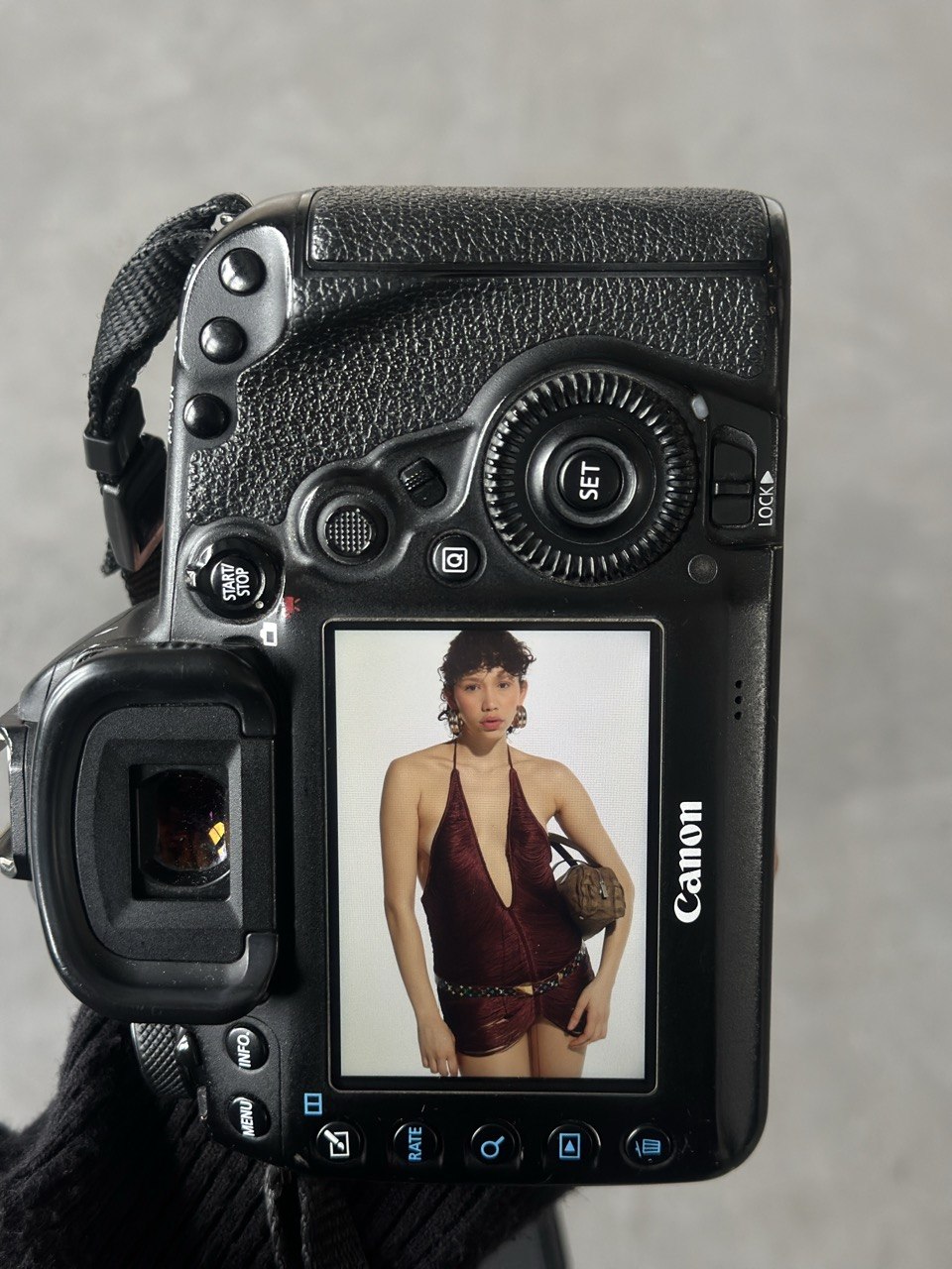 Behind the scenes: a fashion shoot framed on the back of a Canon camera in the studio