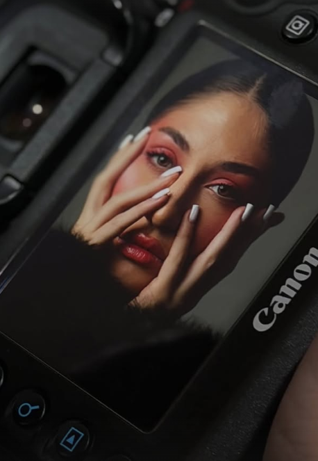 Close-up color portrait of a woman with her hand near her face