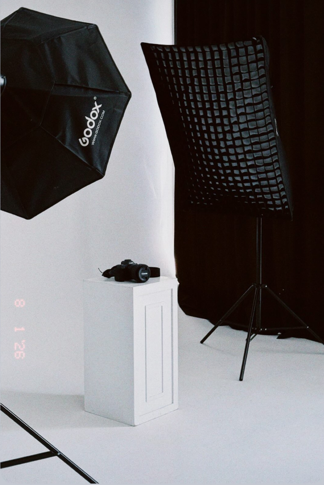 Studio lighting setup with a Godox octabox, gridded softbox and a Canon camera on a pedestal